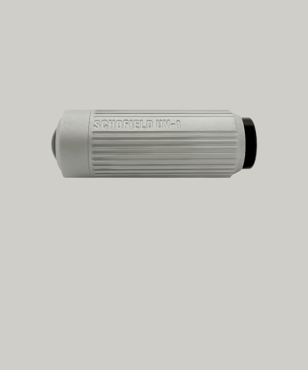 The sleek silver cylindrical device, named "Ultra Violet Torch," resembles a modern flashlight with its textured grip lines and a distinctive black button. Its design suggests an ultra-functional purpose and is elegantly presented against a plain white background.