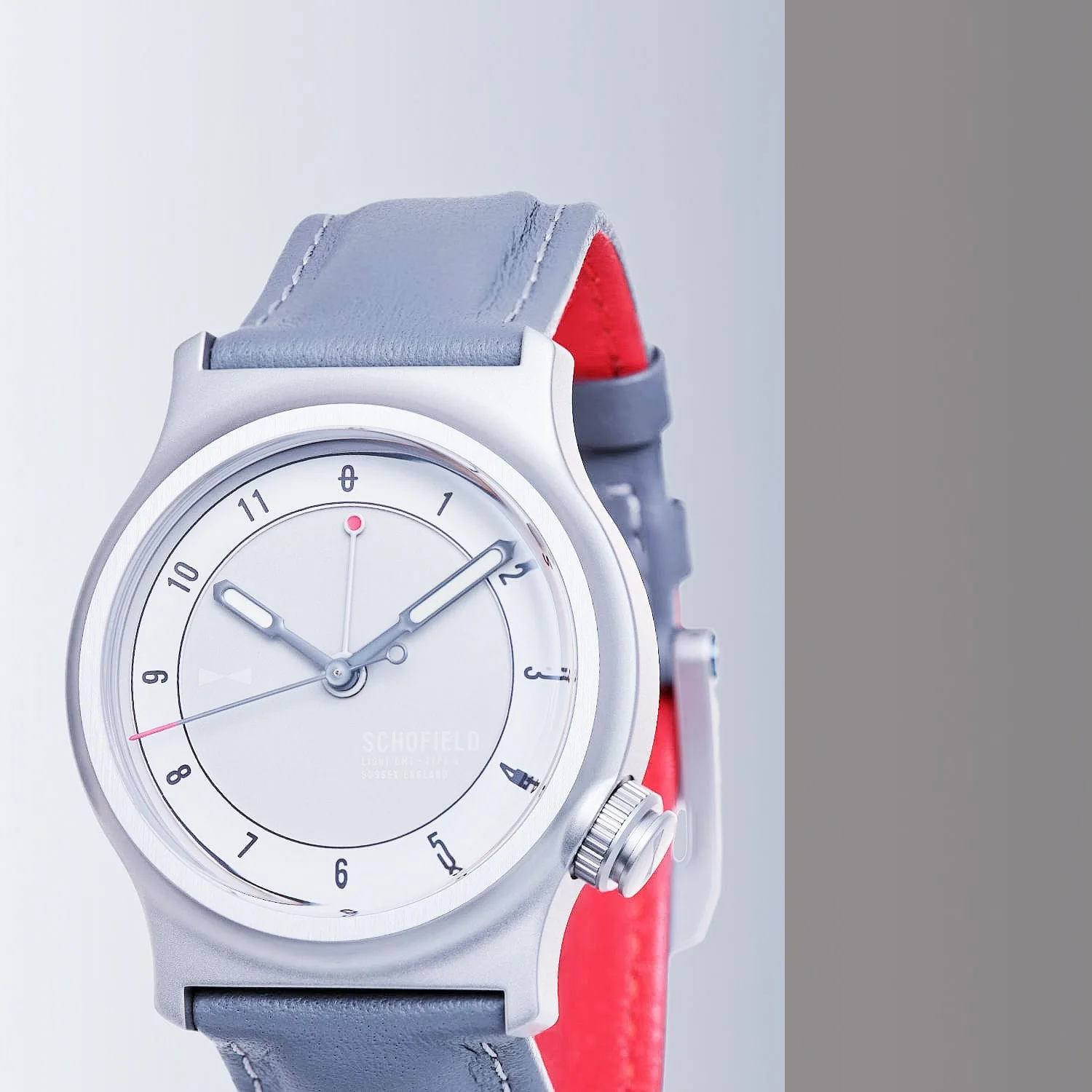 Schofield Light watch - the case is stainless steel with a white and pale grey dial with a GMT hand.