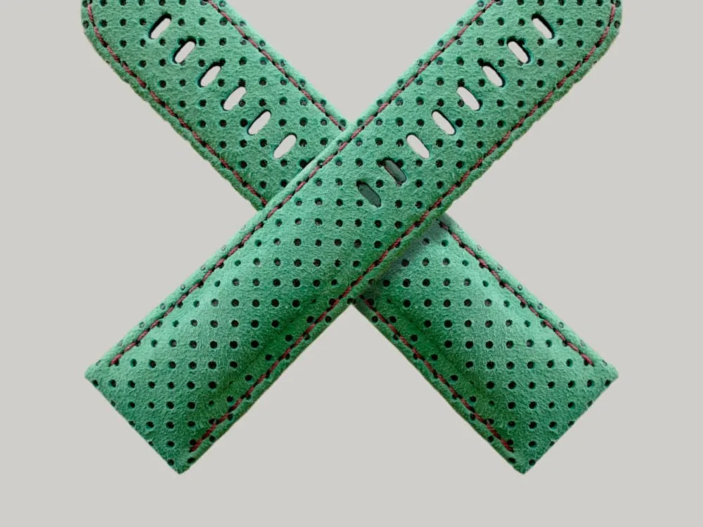 Green Perforated watch straps, Made of suede. The straps feature multiple holes for adjustment and red-brown stitching along the edges.