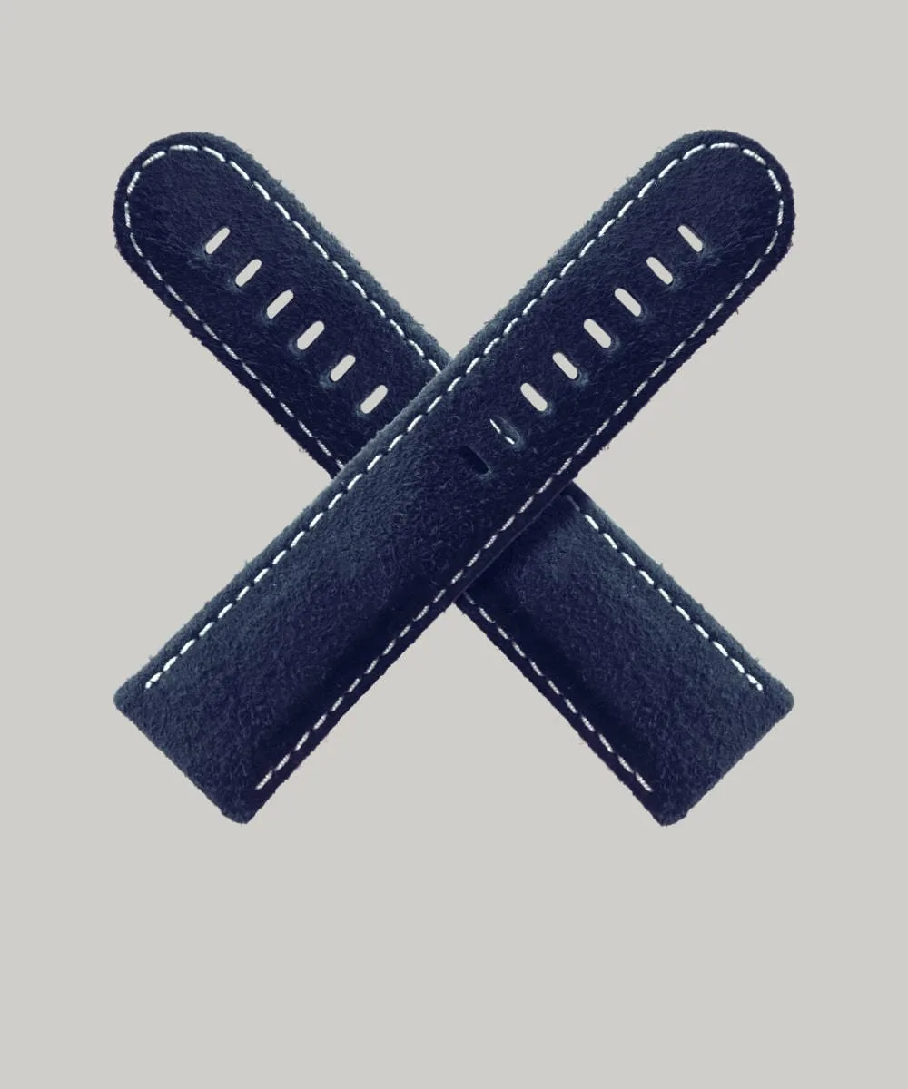 A dark blue tweed watch straps crossed in an 'X' shape against a light grey background. The strap is a refined Moon's fabric and features white stitching along the edges and multiple holes for adjustable sizing.