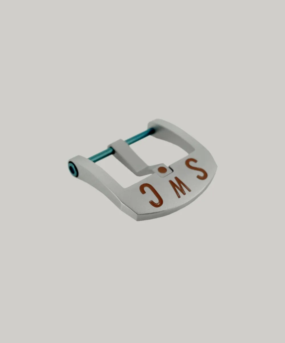 A Brushed BE Buckle with a rectangular frame and blue PVD strap fitting screw. The thumbnail style buckle, called The Best Ever Buckle, features the engraved letters "SWC" in a red paint fill.