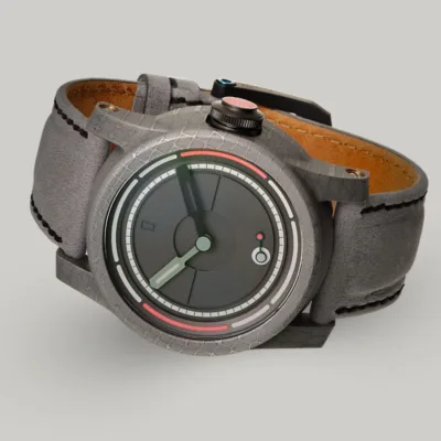 Damascus Steel watch, British made Obscura The British made, unique designed, minimal Obscura watch lying on its side showing the Damascus steel case and lume crown.