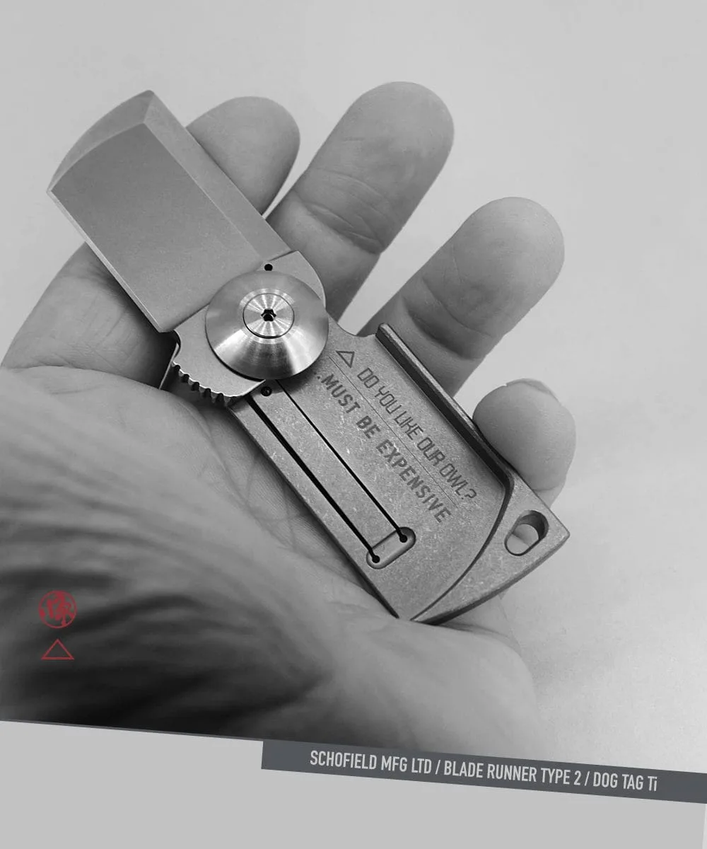A hand holds a compact, rectangular folding knife labeled “MUST BE EXPENSIVE.” The knife has an industrial design and engraved details. The image is in black and white with graphic elements and text at the bottom.