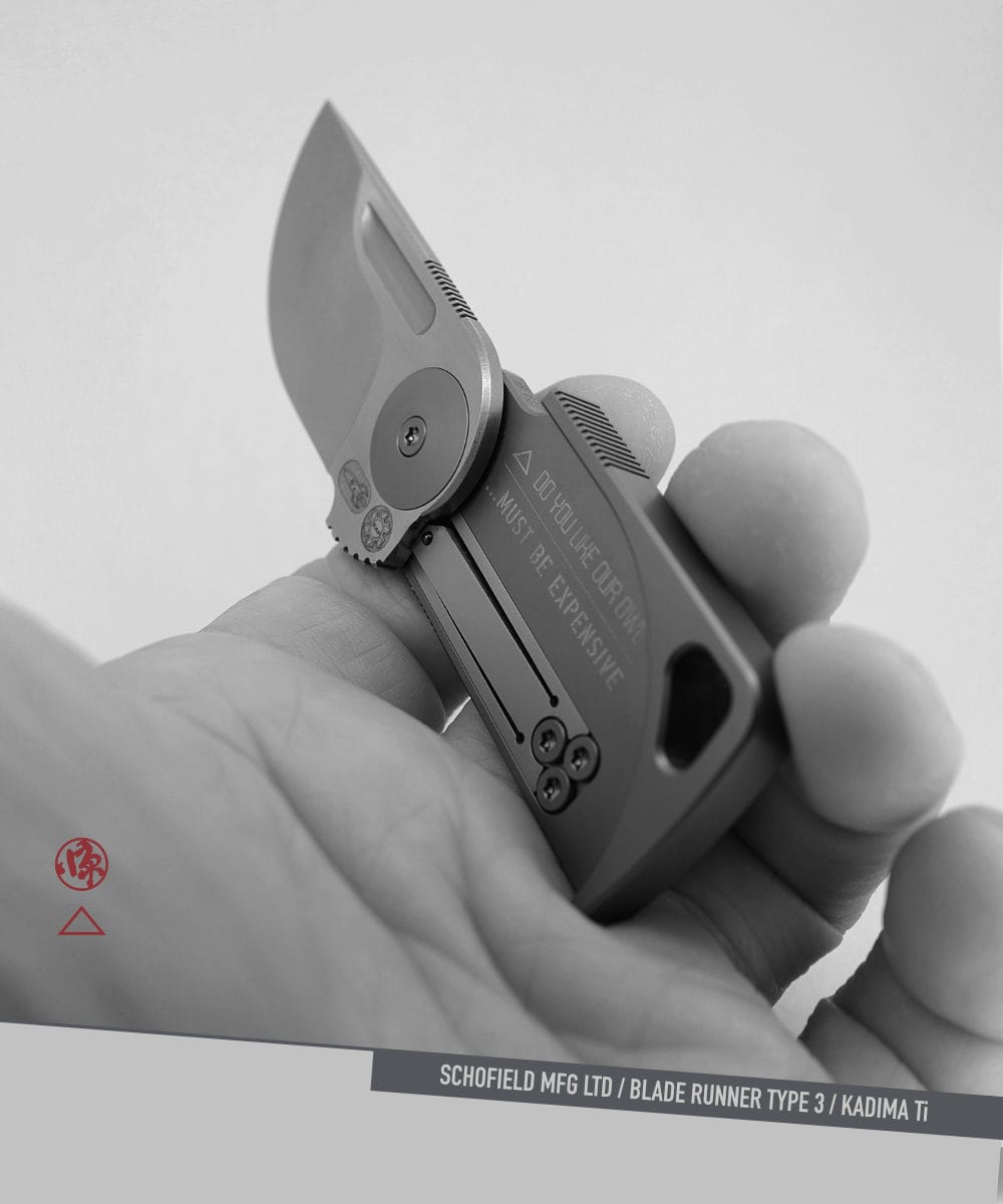Blade runner Knife A hand holds a compact, folding knife with a short blade engraved "...MUST BE EXPENSIVE." The design is modern and made from titanium, with visible screws and a lanyard hole.