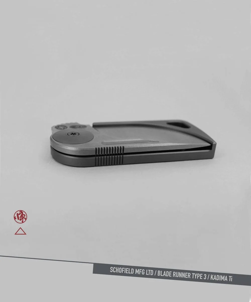 A sleek, modern folding knife with a metallic finish is displayed closed on a light gray background. The text at the bottom reads "SCHOFIELD MFG LTD / BLADE RUNNER TYPE 3 / KADIMA Ti.