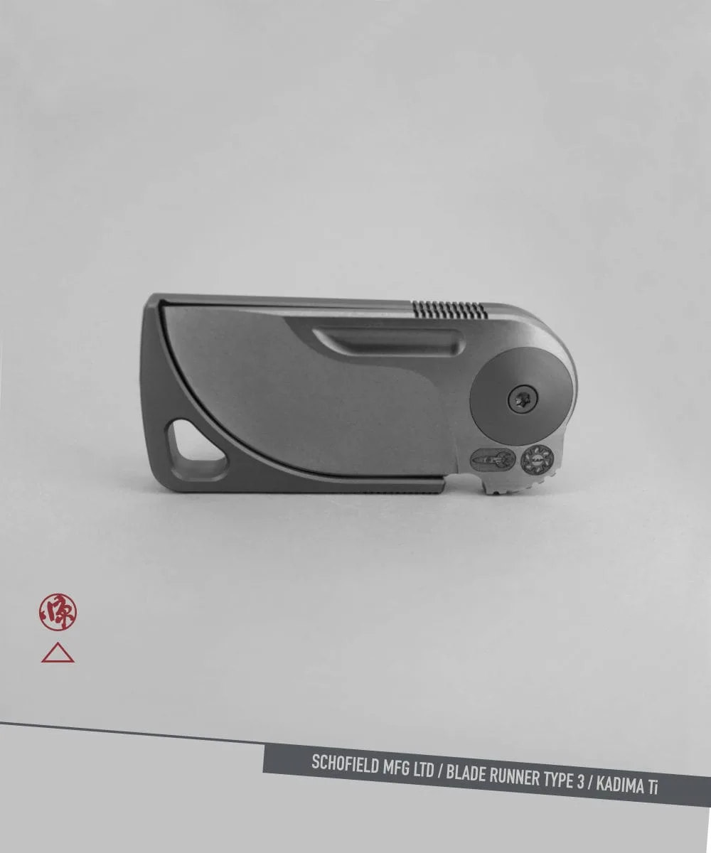 A sleek, modern folding knife with a minimalist design is shown closed against a gray background. The text at the bottom reads "SCHOFIELD MFG LTD / BLADE RUNNER TYPE 3 / KADIMA Ti.
