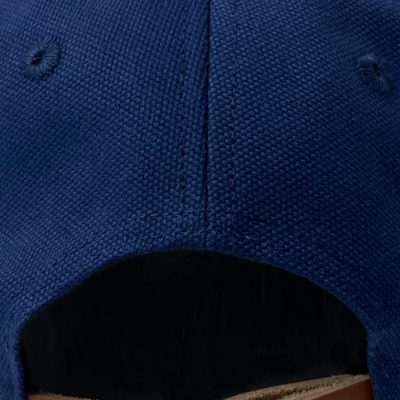 A photo of the Schofield UFO cap back fastening strap made of leather with a black buckle