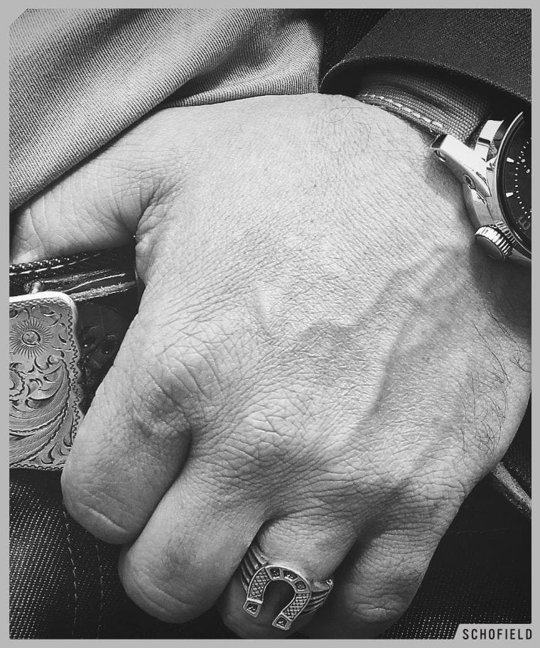 Giles wearing horseshoe ring and jeans and wearing a polished Signalman Watch, Schofield first.