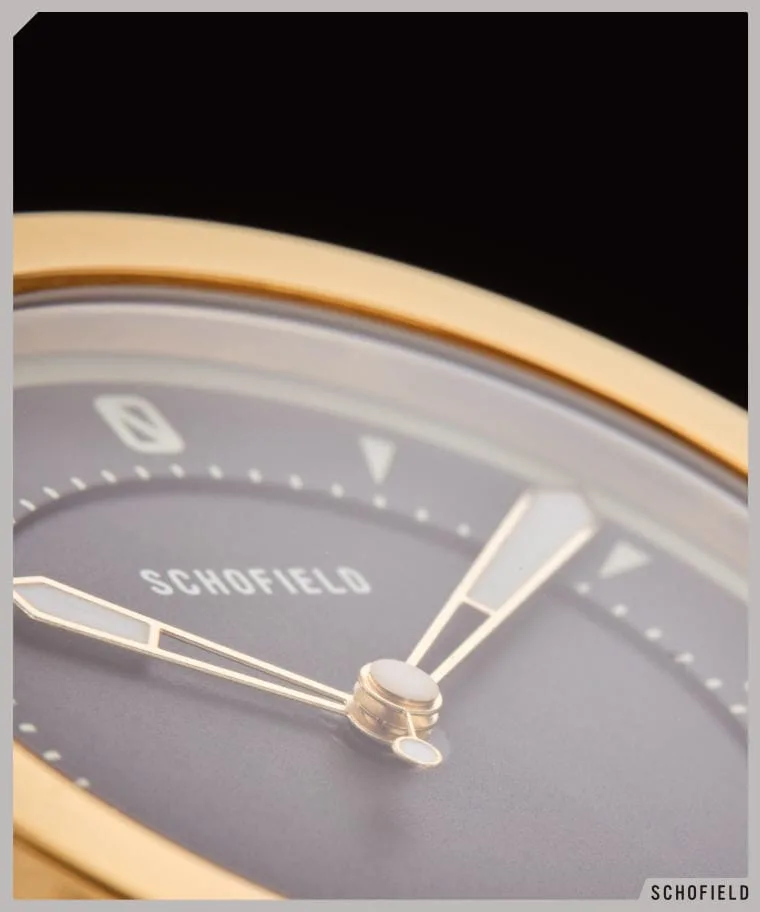 heavy gold watch closeup of black dial