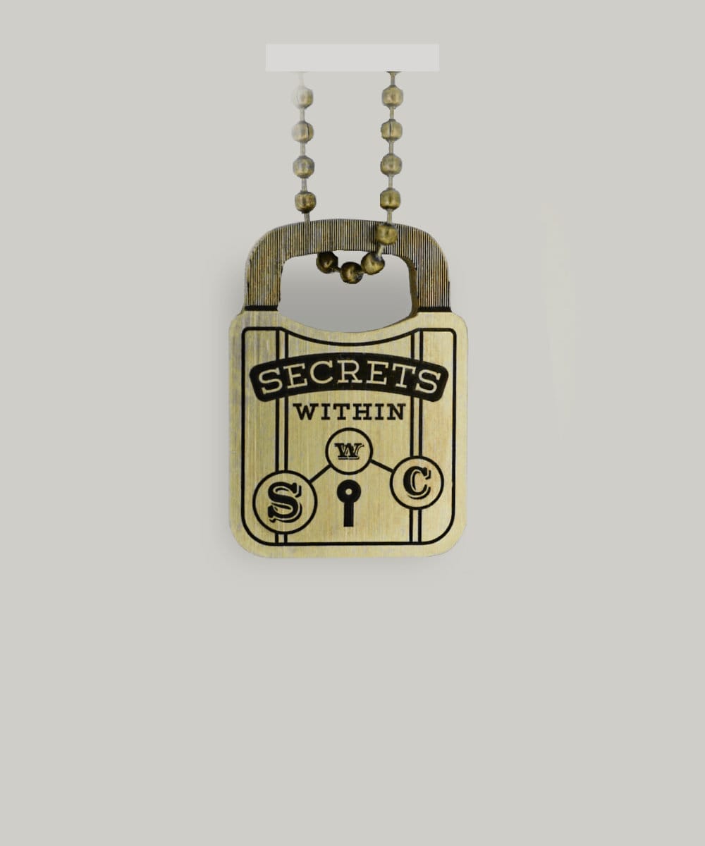 A padlock-shaped brass key ring with "Secrets Within" written on it by Schofield Watch Company
