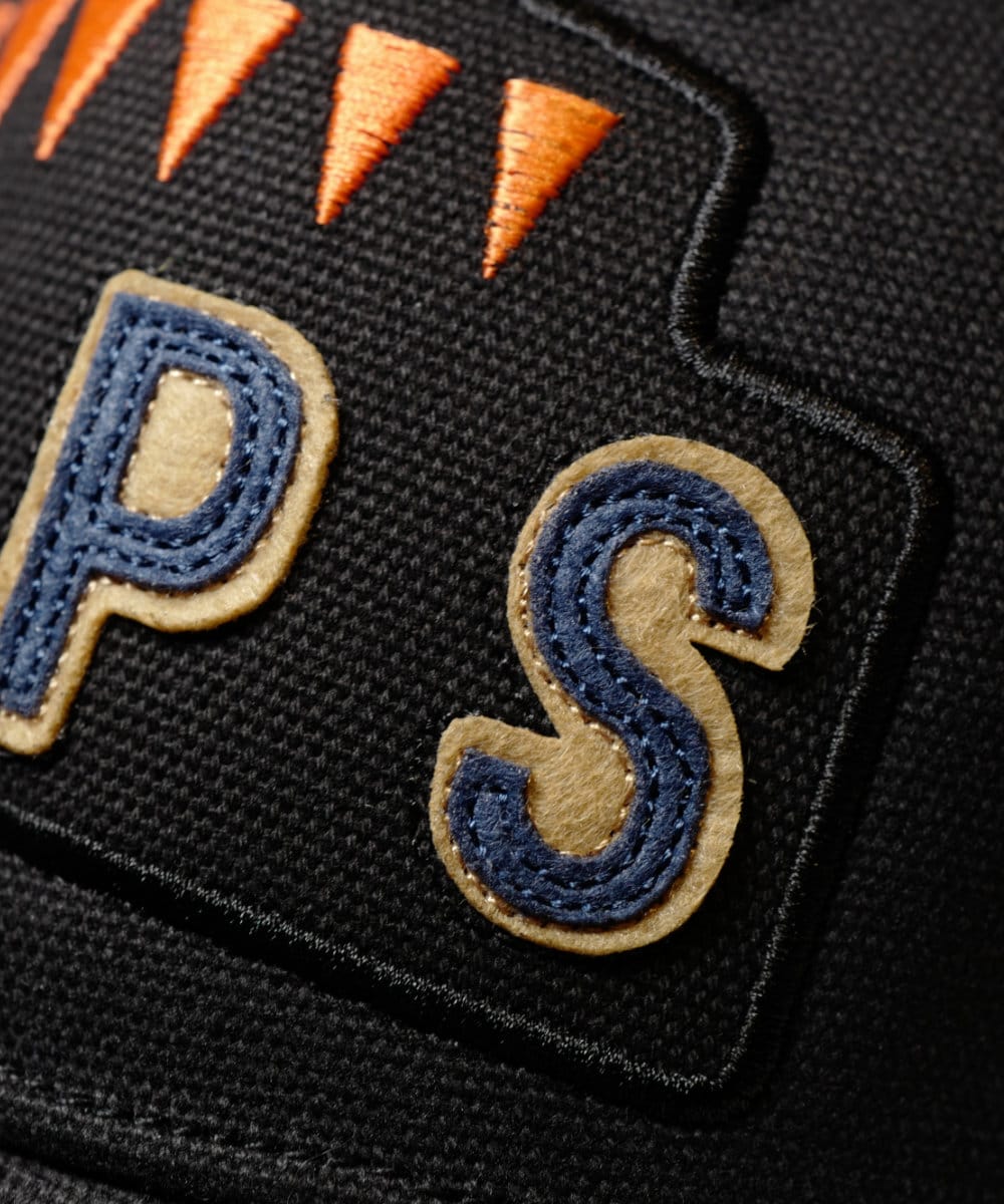 A close up of some letters applied to the front of the Black 6 Pips cap