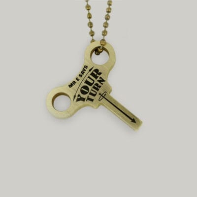 Schofield made a brass keyring with "Mr. E says your turn" in the shape of a clock winding key.
