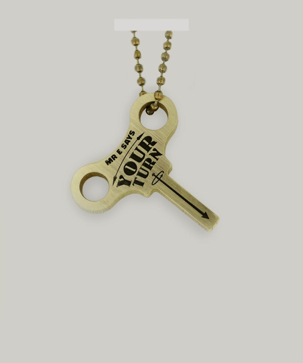 Schofield made a brass keyring with "Mr. E says your turn" in the shape of a clock winding key.
