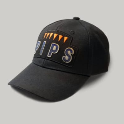 The Six Pips cap with orange pips and blue lettering on a black canvas cap