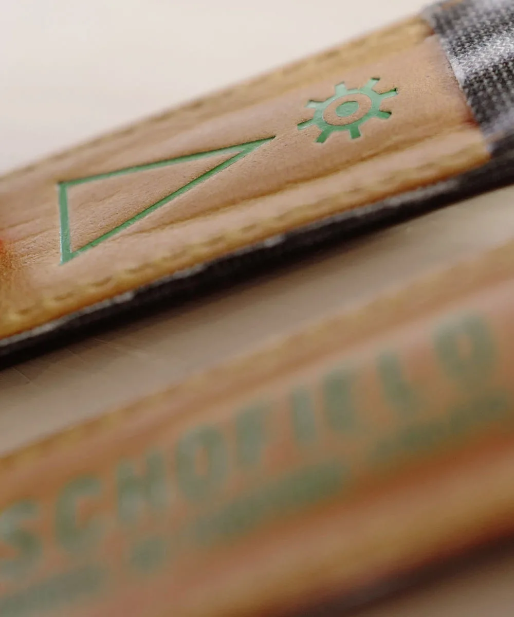 Reverse of a Schofield watch strap Reverse of the OBD watch strap, brown bark leather and green foil logos