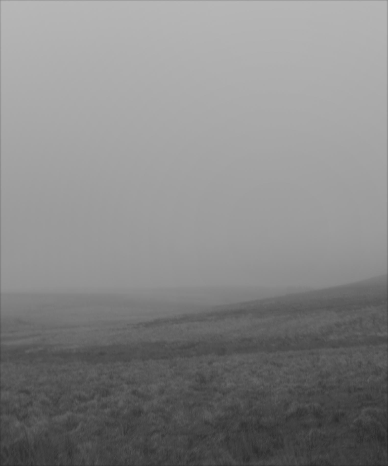 Misty, rainy view over the chains in Exmoor a black-and-white photograph. 